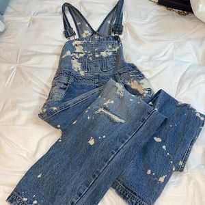 Carmar denim overalls with bleach stain designs and rips.